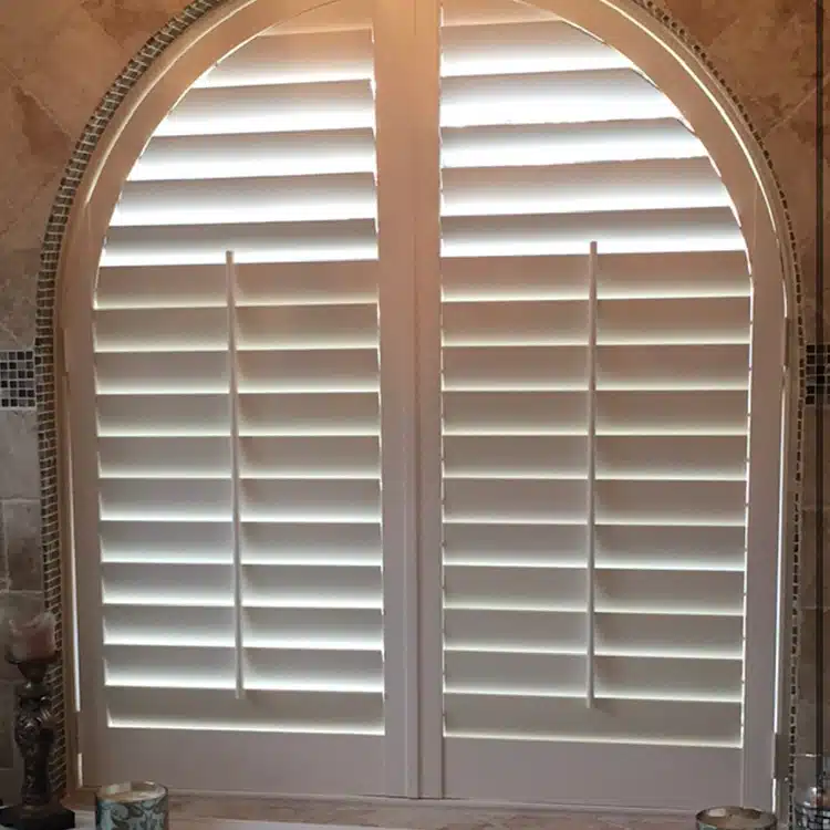 Bathroom window with custom plantation shutters closed for privacy
